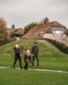 a group of people walking on a path in the grass at Beach Resort Makkum in Makkum