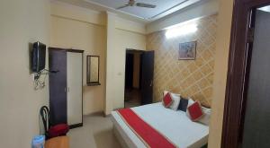 a bedroom with a bed and a television in it at Hotel Shiv Angan in Jaipur