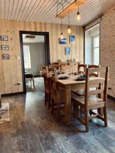 a dining room with a wooden table and chairs at Le Nordmann - au coeur de Gérardmer in Gérardmer