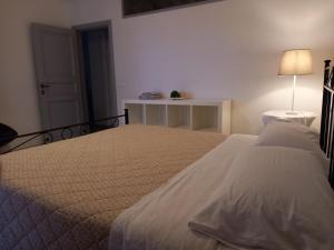 ein Schlafzimmer mit 2 Betten und einem Tisch mit einer Lampe in der Unterkunft L' Antico Comune in Cavriglia