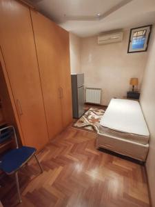 a small room with a bed and a refrigerator at Ameno house in Casale SantʼAntonio