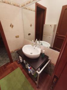 a bathroom with a sink and a mirror at Ameno house in Casale SantʼAntonio