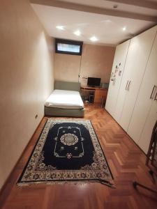 a room with two beds and a rug on the floor at Ameno house in Casale SantʼAntonio