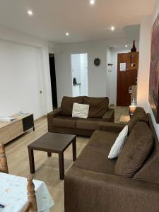 a living room with two brown couches and a table at Nice apartment Soldeu Renttarter in Soldeu