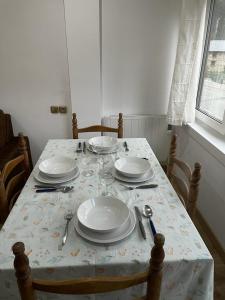 a table with plates and silverware on top of it at Nice apartment Soldeu Renttarter in Soldeu