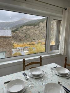 a dining room table with a view of a mountain at Nice apartment Soldeu Renttarter in Soldeu