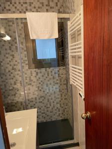 a bathroom with a shower with a sink and a window at Nice apartment Soldeu Renttarter in Soldeu