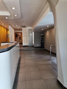 a hallway in a building with a counter and a lobby at Unit 802 Ten South in Durban