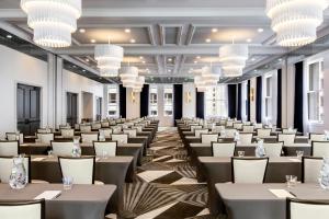 a large room with tables and chairs and chandeliers at Kimpton Gray Hotel Chicago by IHG in Chicago