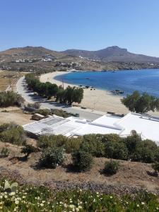 a view of a beach with a building and the water at Villas Kalafatis Apartments in Kalafatis