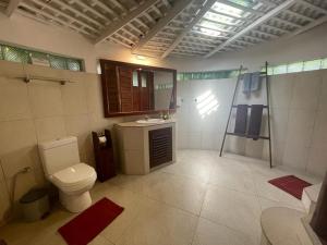 a bathroom with a toilet and a shower and a sink at Rockside Cabanas Hotel in Unawatuna