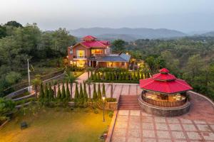 an aerial view of a house with a red roof at StayVista at Dhauladhar House - Luxurious Chateau in Kangra in Dharamshala