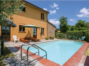 a swimming pool in front of a house at Il Nido country house in Montaione