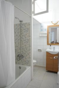 a bathroom with a shower and a toilet and a sink at Apartamentos Playa Calan Blanes in Cala en Blanes