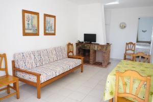 a living room with a couch and a fireplace at Apartamentos Playa Calan Blanes in Cala en Blanes
