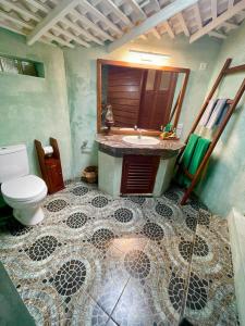 a bathroom with a sink and a toilet at Rockside Cabanas Hotel in Unawatuna