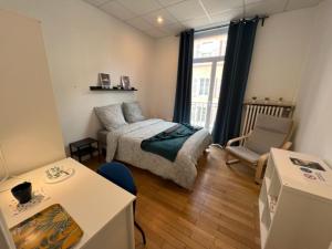 mały pokój z łóżkiem i kanapą w obiekcie Chambres privées -Private room- dans un spacieux appartement - 100m2 centre proche gare w Miluzie