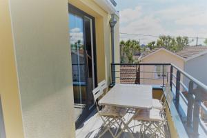 a balcony with a table and chairs on a building at Appartement hyper centre, plage à pieds, 2 chambres, 4 personnes in Châtelaillon-Plage