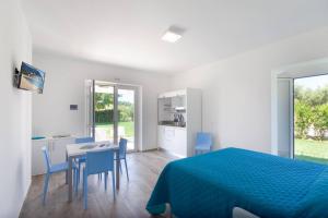 a bedroom with a bed and a table and chairs at Conero Infinito in Numana +7 photos