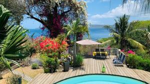 a resort with a swimming pool and a view of the ocean at Les Baobabs in Bandrélé