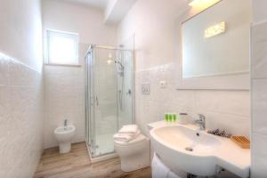a bathroom with a sink and a toilet and a shower at Conero Infinito in Numana