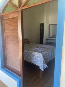 a bedroom with a bed in a room with a window at Pousada Princesa do Mar in Tamandaré