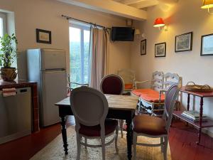 a kitchen and dining room with a table and chairs at Hôtel Particulier des Lumières in Moustiers-Sainte-Marie