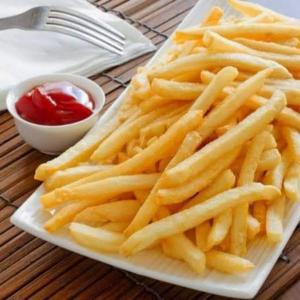 a plate of french fries on a table with ketchup at Peraja Bungalows Loyok in Sangyang