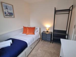 a small bedroom with a bed and a mirror at Sparrowbill House by Cliftonvalley Apartments in Bristol