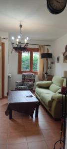 a living room with a couch and a table at Unifamiliar con jardin VU-HUESCA-22-315 in Villanúa +15 photos