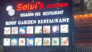 a sign for a root garden restaurant on a building at HOTEL BK SAN in Sengippatti