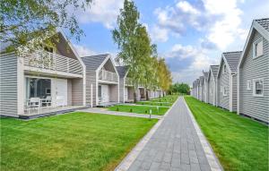 a row of white houses with a green lawn at Cozy Home In Sianozety With Wifi in Sianozety