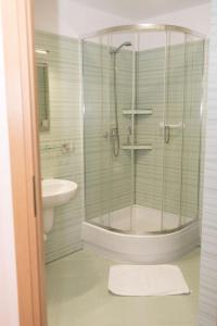 a bathroom with a shower and a sink at Hotel Jaśmin 