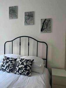 a bedroom with a bed with four pictures on the wall at Stay in the heart of Soho in London