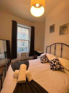 a bedroom with a large bed with pillows and a window at Stay in the heart of Soho in London