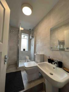 a bathroom with a sink and a toilet and a shower at Stay in the heart of Soho in London