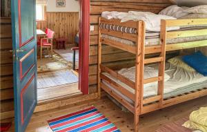 a room with two bunk beds and a table at Nice Home In Lima With Sauna in Lima