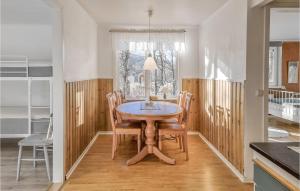 a dining room with a wooden table and chairs at Beautiful Home In Yngered With Wifi 