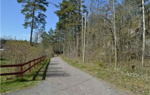 a dirt road with a fence and trees at 4 Bedroom Nice Home In Trosa in Trosa