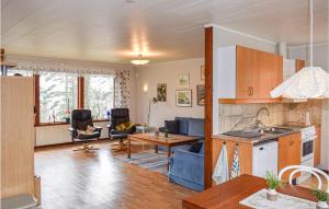 a kitchen and living room with a table and chairs at Beautiful Home In Hyltebruk With Lake View in Hyltebruk