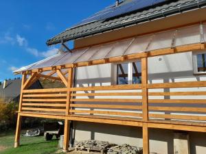 a house with a solar roof on top of it at Sowinka in Lutowiska