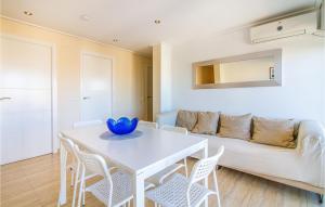 a living room with a table and chairs and a couch at Stunning Apartment In Santa Pola in Santa Pola