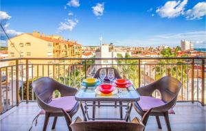 a table on a balcony with a view of a city at Stunning Apartment In Santa Pola in Santa Pola
