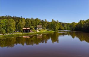 a large lake with a house in the middle at Nice Home In Munkedal With Lake View in Munkedal