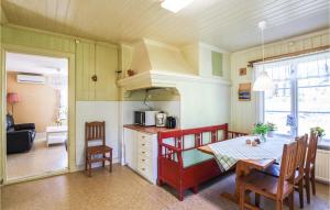 a kitchen and dining room with a table and chairs at Nice Home In Munkedal With Lake View in Munkedal