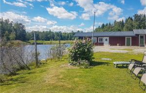 a house with a bench next to a body of water at Nice Home In Ljusne With Wifi in Ljusne