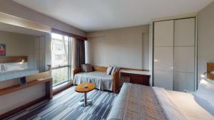 a hotel room with a bed and a window at Mimi Hotel Ankara in Ankara