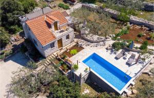 an aerial view of a house with a swimming pool at Amazing Home In Koricenica With House Sea View in Žrnovo