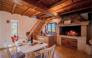 a kitchen with a dining table and a fireplace at Amazing Home In Koricenica With House Sea View in Žrnovo
