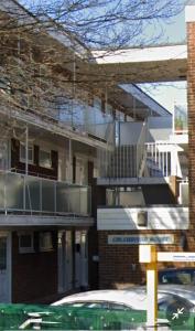 a building with a balcony on the side of it at RentUnique Central Caledonian house cosy home in Crawley